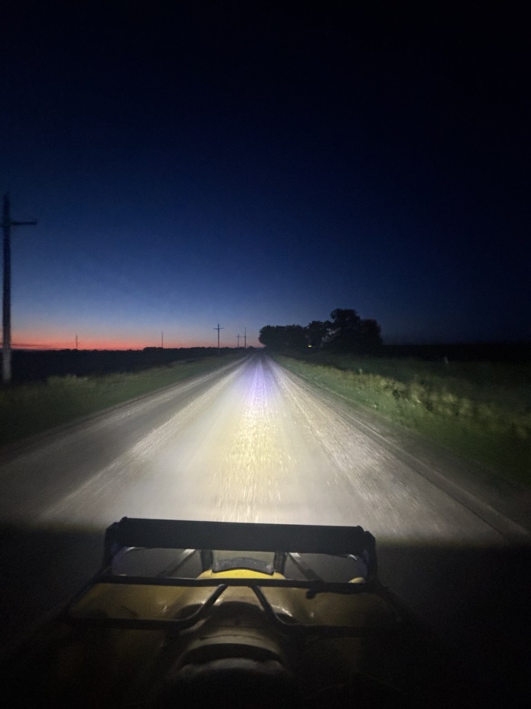 The light bar illuminating a gravel road at dusk